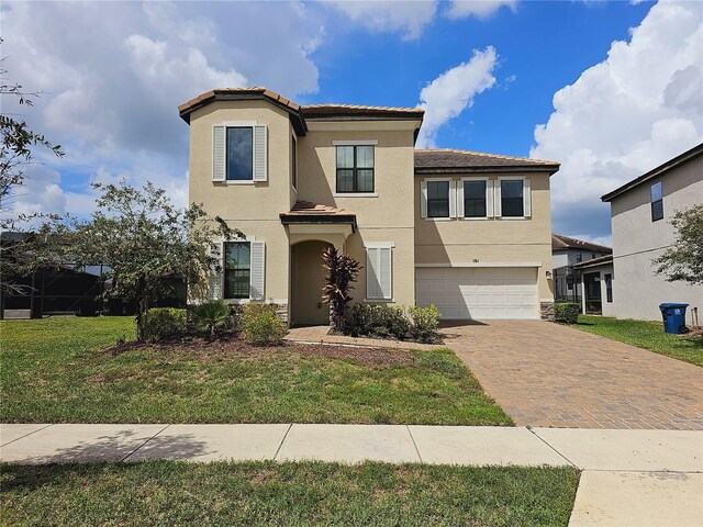 191 Aidans Lndg, Haines City, FL 33844 - view of front facade with stucco siding, a garage, decorative driveway, a tiled roof, and a front lawn