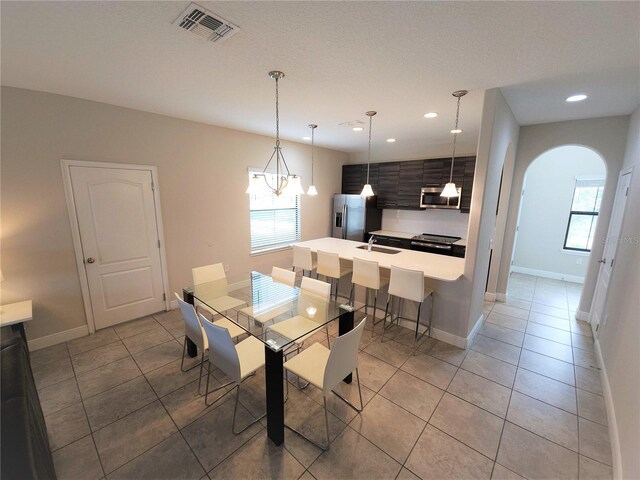 191 Aidans Lndg, Haines City, FL 33844 - dining area with arched walkways, plenty of natural light, light tile patterned flooring, baseboards, and recessed lighting