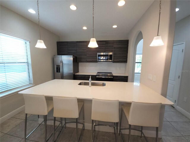 191 Aidans Lndg, Haines City, FL 33844 - kitchen with appliances with stainless steel finishes, a sink, backsplash, recessed lighting, and light countertops