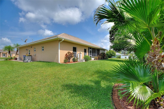 4236 Lakewood Rd, Sebring, FL 33875 - view of property exterior with stucco siding, a yard, and central air condition unit