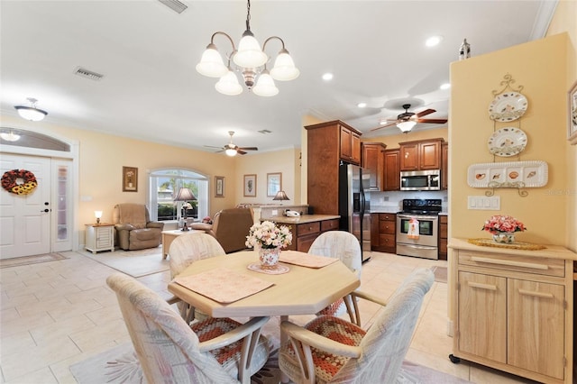 4236 Lakewood Rd, Sebring, FL 33875 - dining space with a ceiling fan, a chandelier, ornamental molding, recessed lighting, and light tile patterned floors