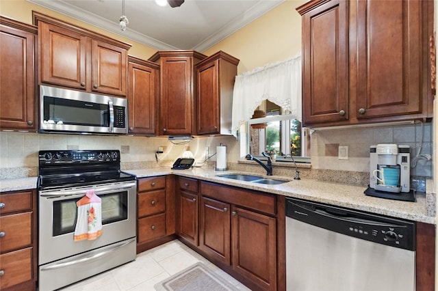 4236 Lakewood Rd, Sebring, FL 33875 - kitchen featuring appliances with stainless steel finishes, crown molding, a sink, backsplash, and light stone counters