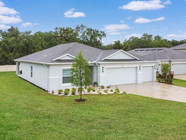 1278 Asher Mason Ave, Kissimmee, FL 34744 - ranch-style home featuring an attached garage, stucco siding, driveway, roof with shingles, and a front lawn