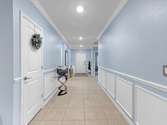 1278 Asher Mason Ave, Kissimmee, FL 34744 - hall featuring ornamental molding, a decorative wall, light tile patterned floors, recessed lighting, and a wainscoted wall
