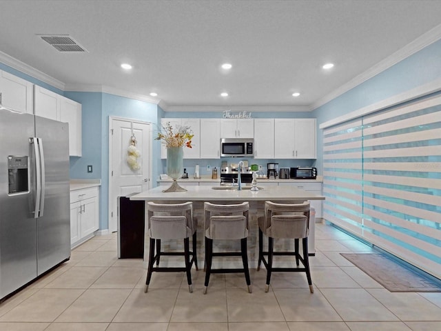 1278 Asher Mason Ave, Kissimmee, FL 34744 - kitchen with stainless steel appliances, a sink, crown molding, a breakfast bar area, and light countertops