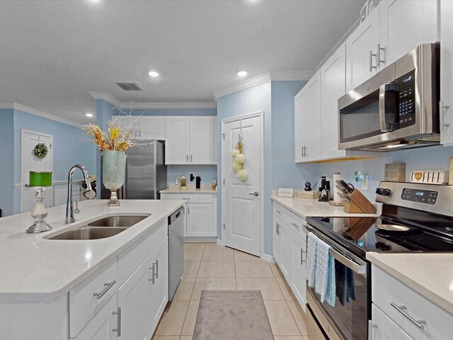 1278 Asher Mason Ave, Kissimmee, FL 34744 - kitchen with stainless steel appliances, a sink, crown molding, white cabinets, and light countertops