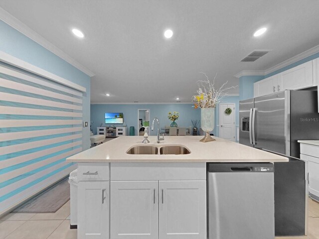 1278 Asher Mason Ave, Kissimmee, FL 34744 - kitchen featuring stainless steel appliances, a sink, ornamental molding, white cabinetry, and a kitchen island with sink