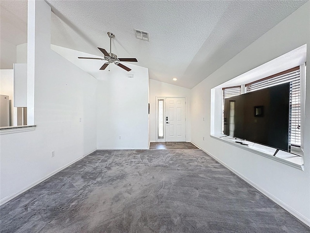 1428 Park Pl, Haines City, FL 33844 - unfurnished living room with lofted ceiling, a ceiling fan, carpet flooring, and a textured ceiling
