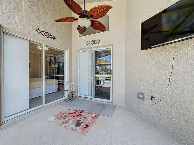 1428 Park Pl, Haines City, FL 33844 - view of exterior entry with a ceiling fan, a patio, and stucco siding