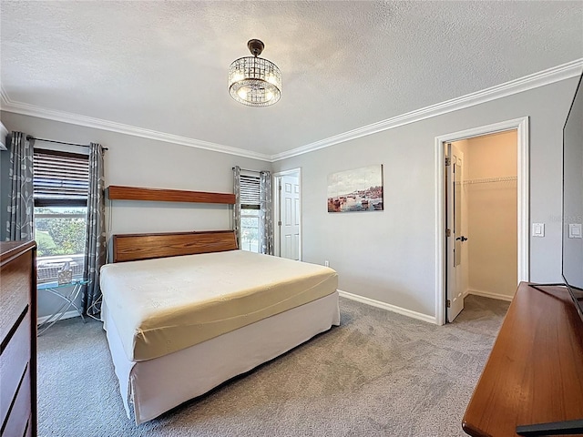 1428 Park Pl, Haines City, FL 33844 - carpeted bedroom featuring crown molding, a spacious closet, a textured ceiling, and a chandelier