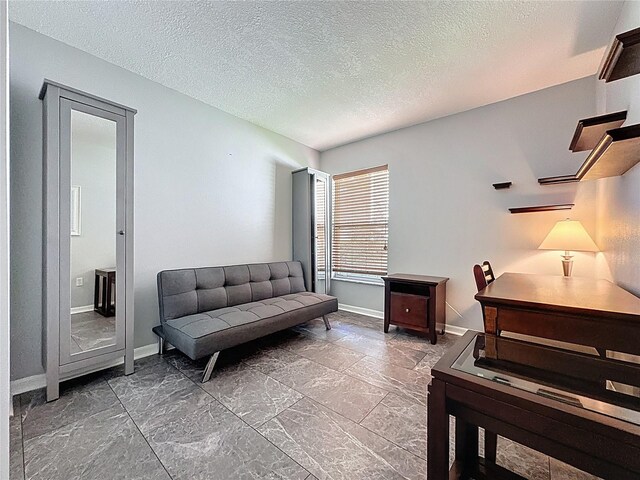 1428 Park Pl, Haines City, FL 33844 - sitting room with baseboards and a textured ceiling