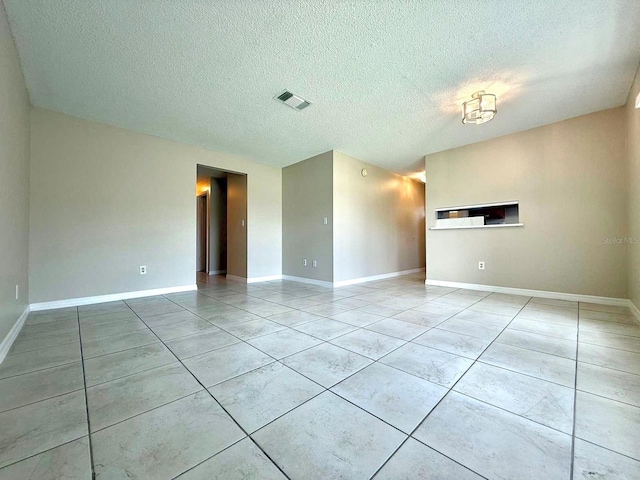 1001 Plantation Dr Unit E1, Kissimmee, FL 34741 - unfurnished living room with baseboards, a textured ceiling, and light tile patterned floors