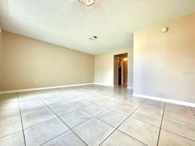 1001 Plantation Dr Unit E1, Kissimmee, FL 34741 - unfurnished room with a textured ceiling, light tile patterned floors, baseboards, and a smoke detector