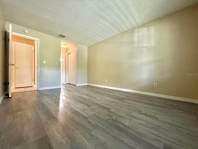 1001 Plantation Dr Unit E1, Kissimmee, FL 34741 - spare room featuring a textured ceiling, wood finished floors, and baseboards
