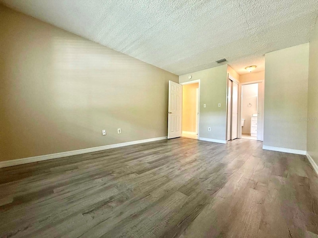 1001 Plantation Dr Unit E1, Kissimmee, FL 34741 - unfurnished room featuring wood finished floors, a textured ceiling, and baseboards
