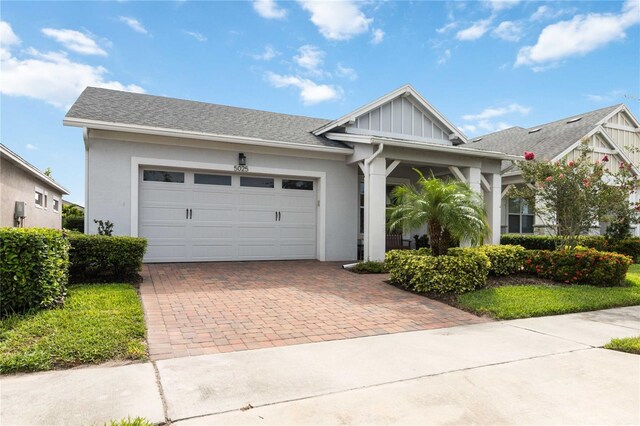5025 Sunfalls Ave, Saint Cloud, FL 34772 - view of front of home with decorative driveway, an attached garage, and stucco siding