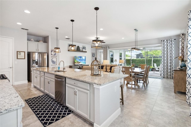 5025 Sunfalls Ave, Saint Cloud, FL 34772 - kitchen with stainless steel appliances, a sink, recessed lighting, a center island with sink, and decorative light fixtures