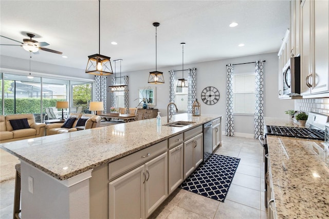 5025 Sunfalls Ave, Saint Cloud, FL 34772 - kitchen with stainless steel appliances, a sink, a ceiling fan, plenty of natural light, and recessed lighting
