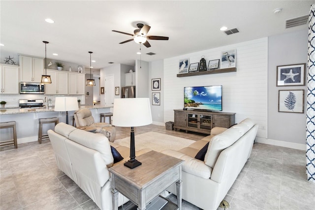 5025 Sunfalls Ave, Saint Cloud, FL 34772 - living area with ceiling fan, recessed lighting, light tile patterned flooring, and baseboards