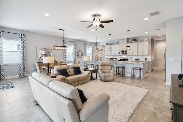 5025 Sunfalls Ave, Saint Cloud, FL 34772 - living area featuring ceiling fan, recessed lighting, plenty of natural light, baseboards, and light tile patterned floors