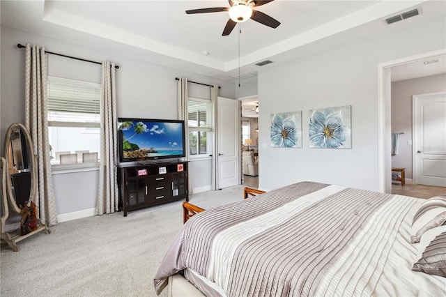 5025 Sunfalls Ave, Saint Cloud, FL 34772 - bedroom featuring baseboards, light colored carpet, a tray ceiling, and a ceiling fan