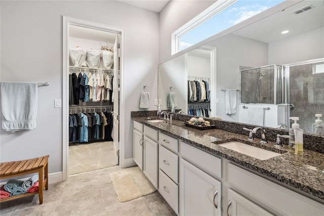 5025 Sunfalls Ave, Saint Cloud, FL 34772 - full bathroom with double vanity, a walk in closet, a stall shower, and plenty of natural light