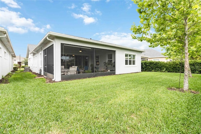5025 Sunfalls Ave, Saint Cloud, FL 34772 - rear view of property with a lawn, a sunroom, and central air condition unit