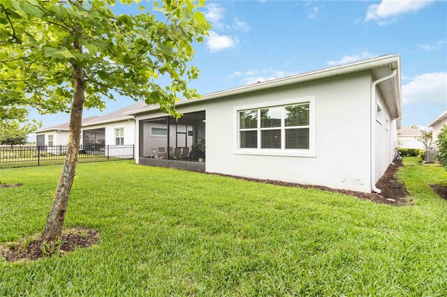 5025 Sunfalls Ave, Saint Cloud, FL 34772 - back of property with a sunroom, stucco siding, and cooling unit