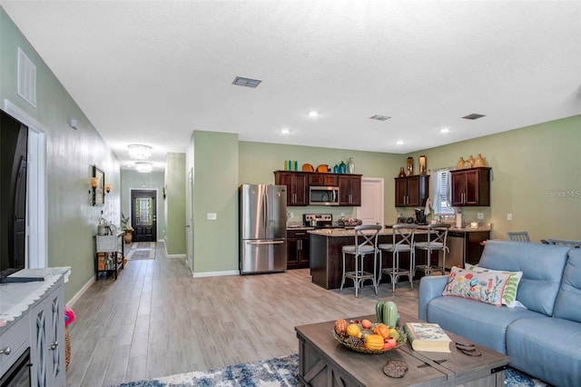 1096 Roberta Rd, Lake Wales, FL 33853 - living room featuring light wood-type flooring, baseboards, and recessed lighting