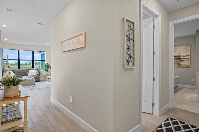 6288 Winding Pine Dr, Nokomis, FL 34275 - hall featuring baseboards, light wood-style floors, and recessed lighting