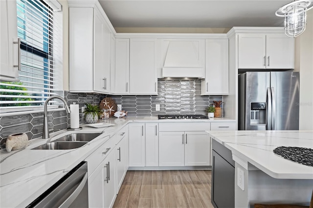 6288 Winding Pine Dr, Nokomis, FL 34275 - kitchen with appliances with stainless steel finishes, custom exhaust hood, a sink, and white cabinets