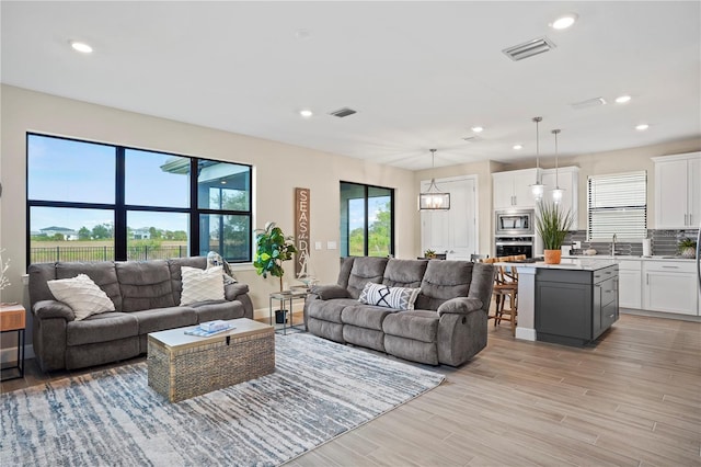 6288 Winding Pine Dr, Nokomis, FL 34275 - living room with recessed lighting and light wood finished floors