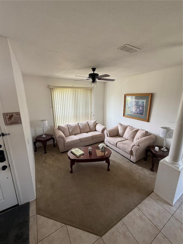 939 Jaybee Ave, Davenport, FL 33897 - living room featuring light carpet, a ceiling fan, light tile patterned floors, and a textured ceiling