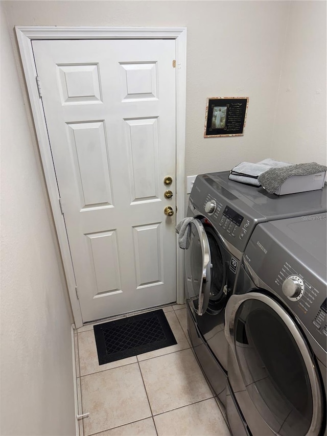939 Jaybee Ave, Davenport, FL 33897 - laundry room with washing machine and dryer and light tile patterned floors