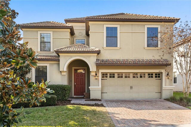 1456 Belle Terre Rd, Davenport, FL 33896 - view of front of home with a tile roof, decorative driveway, stucco siding, and a garage