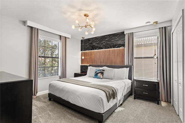 1456 Belle Terre Rd, Davenport, FL 33896 - bedroom featuring light carpet, a chandelier, baseboards, and an accent wall
