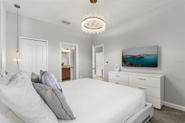 1456 Belle Terre Rd, Davenport, FL 33896 - bedroom with a chandelier, baseboards, connected bathroom, and carpet floors
