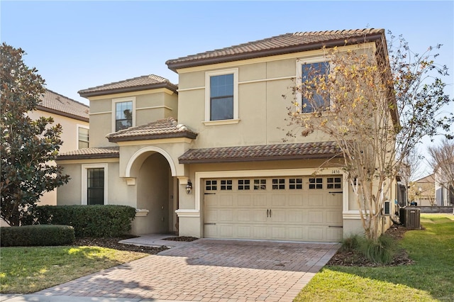 1456 Belle Terre Rd, Davenport, FL 33896 - view of front of house featuring central AC unit, a tile roof, decorative driveway, and a garage