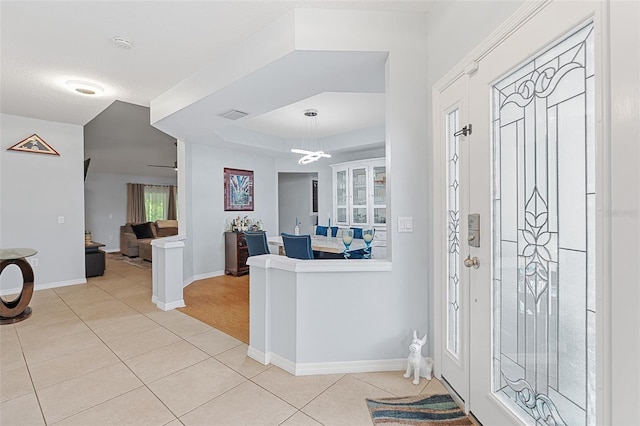 1523 Stafford Ave, Merritt Island, FL 32952 - foyer featuring light tile patterned floors, baseboards, a raised ceiling, and a chandelier
