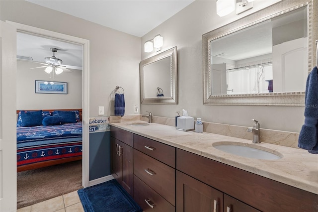 1523 Stafford Ave, Merritt Island, FL 32952 - bathroom with double vanity, tile patterned flooring, connected bathroom, and ceiling fan