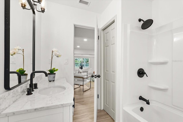 304 W 24th St, Sanford, FL 32771 - bathroom with vanity,  shower combination, and wood finished floors