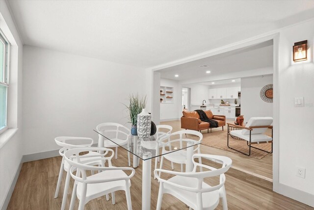 304 W 24th St, Sanford, FL 32771 - dining room featuring baseboards, light wood-type flooring, recessed lighting, and healthy amount of natural light