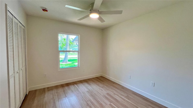 560 Gateway Dr, Merritt Island, FL 32952 - unfurnished bedroom with light wood-style floors, baseboards, a closet, and ceiling fan