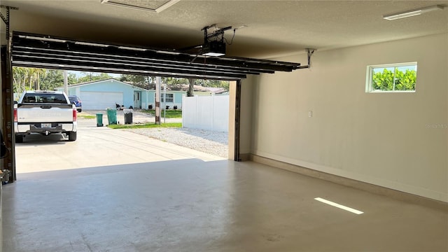 560 Gateway Dr, Merritt Island, FL 32952 - garage with a garage door opener and baseboards