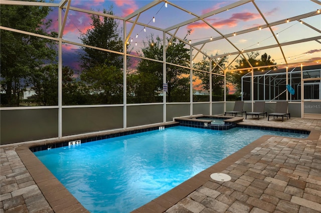 1560 Maidstone Ct, Davenport, FL 33896 - view of swimming pool featuring a patio, a pool with connected hot tub, and glass enclosure