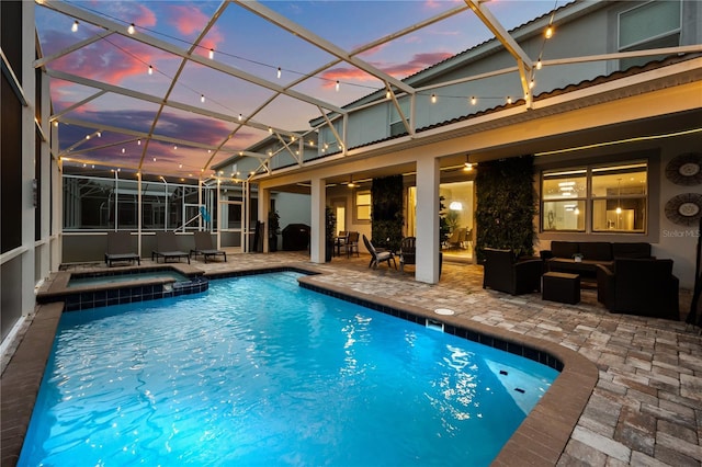 1560 Maidstone Ct, Davenport, FL 33896 - pool at dusk featuring a patio, an outdoor hangout area, a pool with connected hot tub, and a lanai