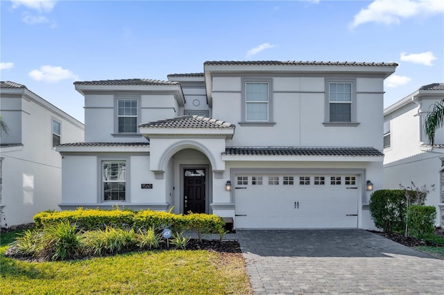 1560 Maidstone Ct, Davenport, FL 33896 - view of front of property featuring a tiled roof, decorative driveway, stucco siding, and an attached garage