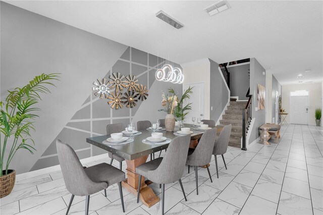 1560 Maidstone Ct, Davenport, FL 33896 - dining space with stairway, light marble finish floors, and baseboards