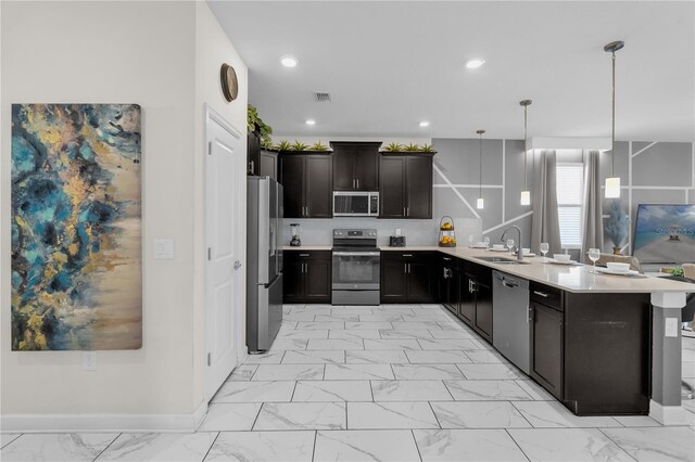 1560 Maidstone Ct, Davenport, FL 33896 - kitchen featuring appliances with stainless steel finishes, light marble finish flooring, light countertops, a peninsula, and recessed lighting