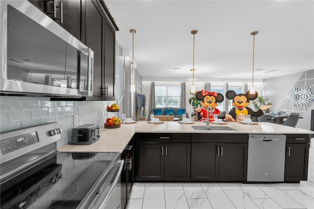 1560 Maidstone Ct, Davenport, FL 33896 - kitchen featuring stainless steel appliances, a sink, light countertops, and dark cabinets